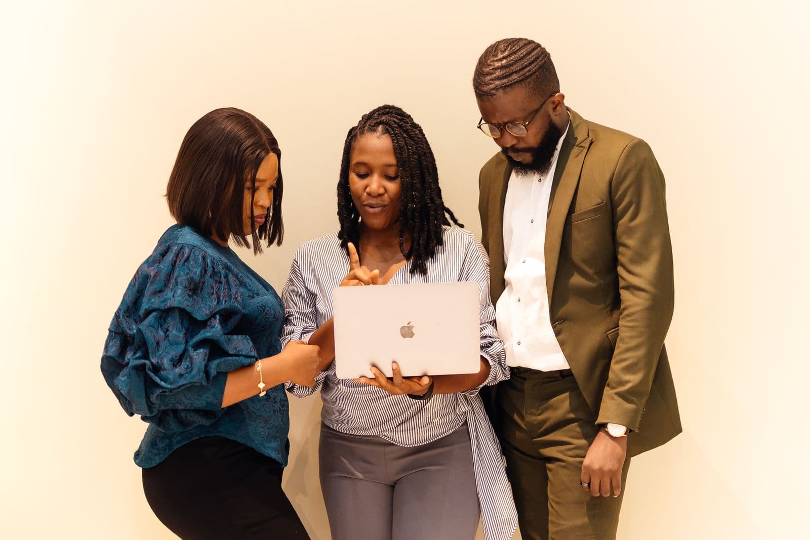 A team in a Lagos office looking at a laptop